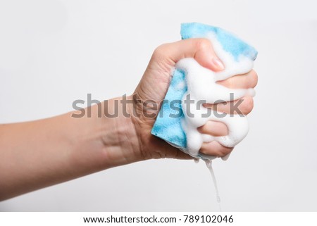 Sponge for washing dishes in hand Royalty-Free Stock Photo #789102046
