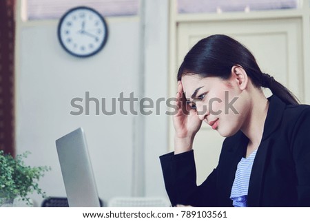 Business women sit and strain the computer screen for a long time. Because the work has been overloaded.