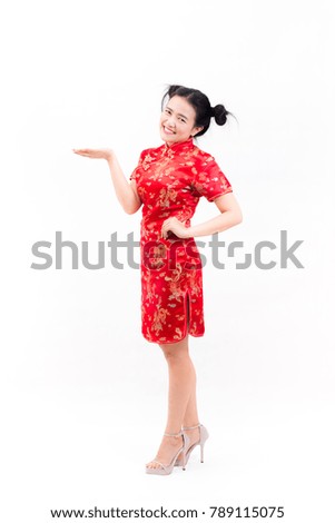 Young asian woman wearing chinese dress traditional cheongsam with gesture of congratulation, Looking at the camera and smile in Chinese New Year Festivities, New Year Celebration on white background.
