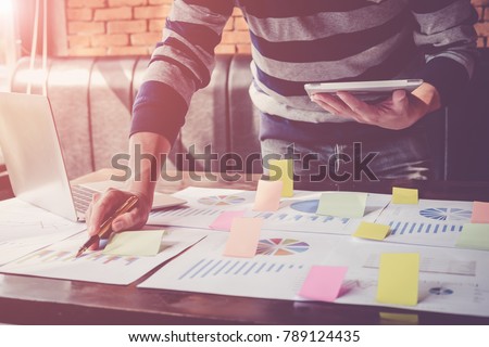 Asian business man hand holding note paper meeting with new startup project use post it notes to share idea discussion and analysis data charts and graphs.Business finances and accounting concept
 Royalty-Free Stock Photo #789124435