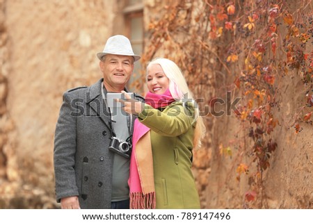 Happy mature couple taking selfie outdoors