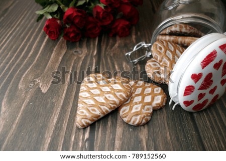 Heart-shaped gingerbread on wooden table, valentine`s day and love concept