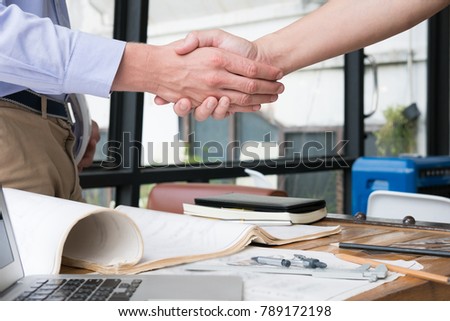 engineer handshaking for successful deal in construction plan. young architect shake hand for agreement in new business project at workplace.