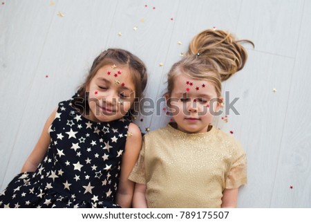 two girls close eyes glitter star face