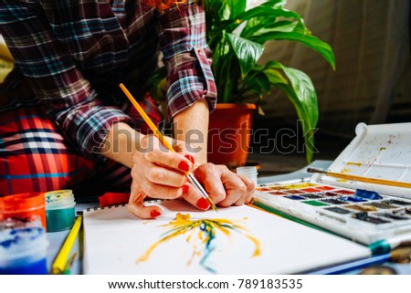 adult woman artist busy drawing a picture