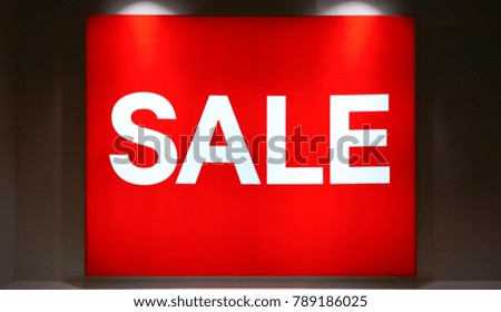 window display with white text "'SALE'" on red color background, sale light box banner at fashion store in shopping mall on black Friday for Christmas