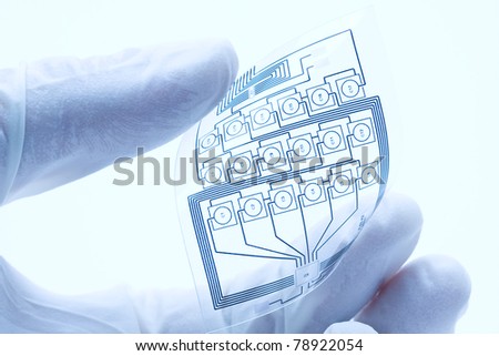 Technician holding a flexible electric circuit layout Royalty-Free Stock Photo #78922054