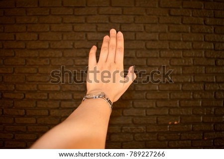 Hand of a young girl and a chocolate wall of sweet love