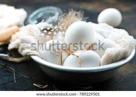 raw eggs on pkate and on a table, stock photo