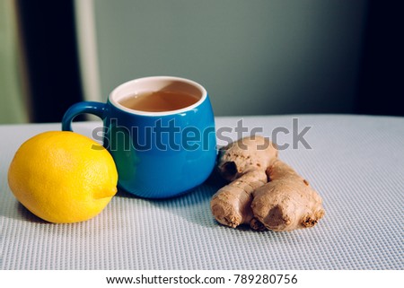 Blue cup of herbal tea with ginger and lemon, healthy lifestyle