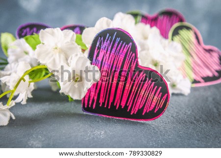 Homemade Black violet pink hearts on a gray concrete background. The concept of Valentine's Day. A symbol of love