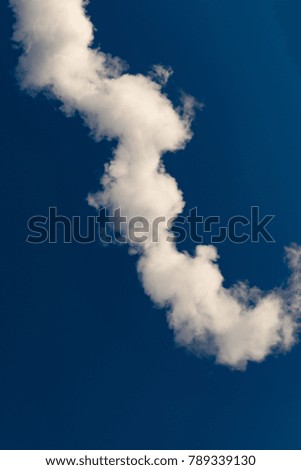 thick white smoke on a background of blue sky, abstract background