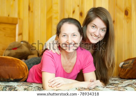 appy mother with her teenager daughter in home interior