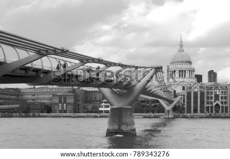 The Millennium Bridge is a pedestrian suspension bridge made of steel, which crosses the River Thames in the city of London. Behind it you can see the cathedral of st. paul
