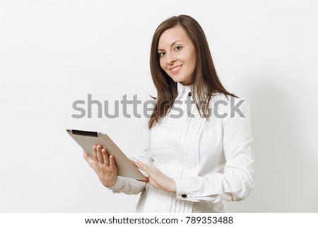 Beautiful happy caucasian young smiling brown-hair business woman in white shirt holding and working in tablet isolated on white background. Manager, student or worker. Copy space for advertisement