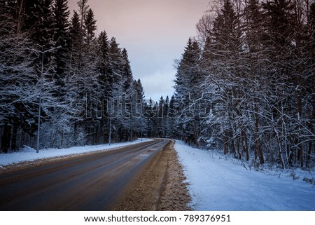 Snowy winter road with a turn in Russia