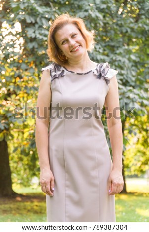 Portrait of Attractive Smiling Caucasian Ethnicity Young Woman in the park.