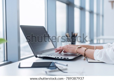 Female copywriter at her workplace, home, writing new text using laptop and Wi-Fi internet connection in the morning. Royalty-Free Stock Photo #789387937