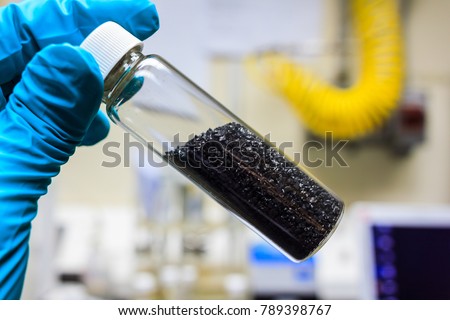 activated carbon or granular in clear bottle is used in air purification, decaffeinate, gold purification, metal extraction, water purification, medicine, sewage treatment, air filters in gas masks Royalty-Free Stock Photo #789398767