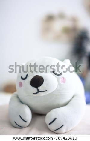 Lazy White bear is sleeping on the bed