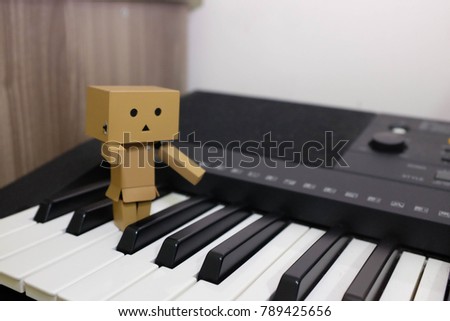 A toy on a piano key with selective focus. Let's play some music.