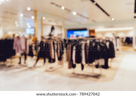Clothing boutique in fashion shopping mall, abstract blur.