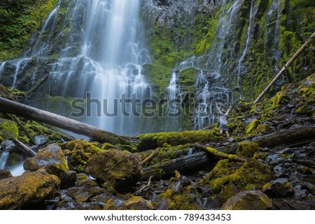 Woman Stands with her Arms Raised at Proxy Falls in central Oregon