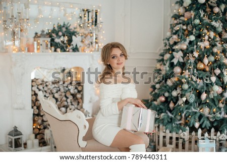 Happy young blonde girl in Christmas decorations