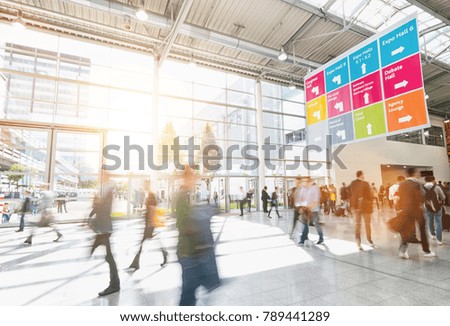large crowd of anonymous business people at a trade show