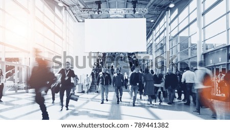 people at a trade show, including copy space banner 