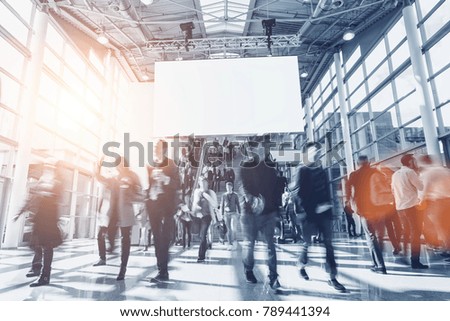 crowd of anonymous blurred people at a trade show