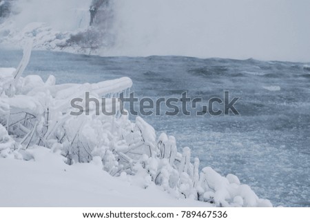 Cold weather, frozen water, snow on branches, icicles, freezing winter wonderland, Canadian, Antarctica, North Pole, background 