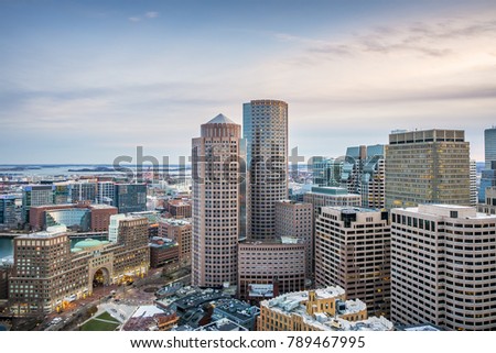 Aerial view of Boston in Massachusetts, USA at sunset showcasing the Boston Harbor and Financial District.