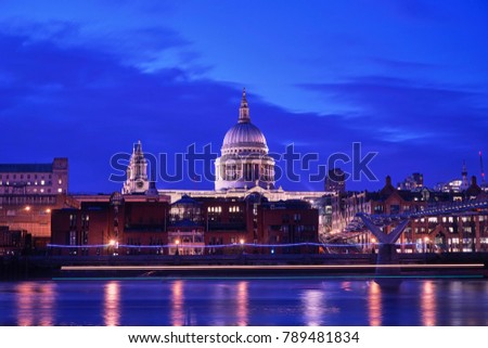 St. Paul's Cathedral Light up at Twilight with Millennium Bridge and Light Trail of Boat in Thames River