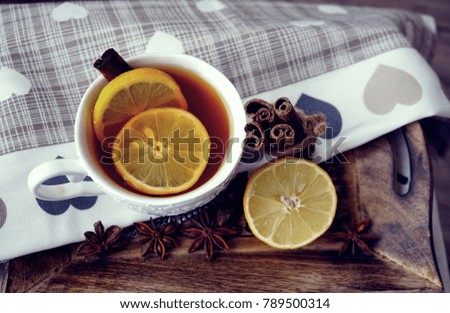 Hot tea in white cup with lemon. Selective focus, top view. Still life, food and drink, seasonal and holiday concept