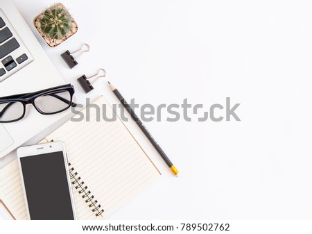 White office desk table, workspace office with laptop, smartphone black screen,pen,calculator, glasses, Top view with copy space