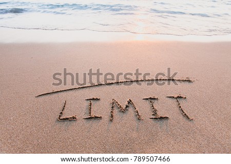limit concept, line and word on the sand Royalty-Free Stock Photo #789507466