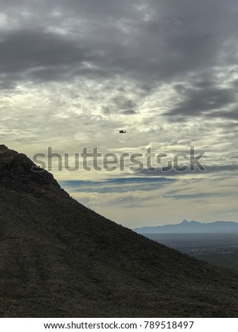 Tucson Mountain National Park - View Of a helicopter in the cloudy sky, and mountain valley views.