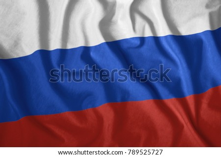 The Russian flag is flying in the wind. Colorful, national flag of Russia. Patriotism.