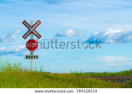 Railway tracks with stop sign in a farmers field