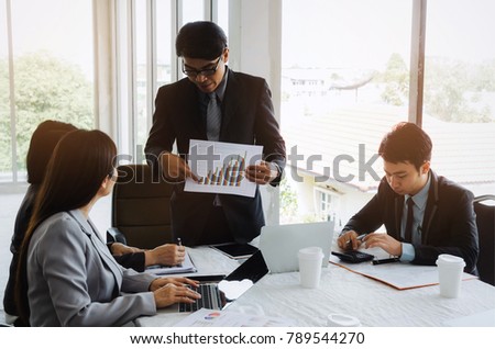 asian project manager showing and presenting growth chart diagram of financial report or results of the year in meeting room at office, investment, company success, and teamwork  concept, vintage tone