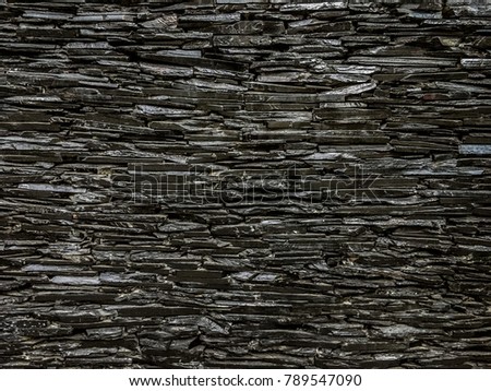 Black granite stone wall texture background