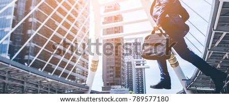 Businessman with a briefcase running fast in a city street on a background rush hour Royalty-Free Stock Photo #789577180