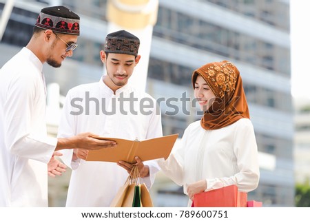 Muslim teen group reading book with shopping in the city,Concept education and shopping