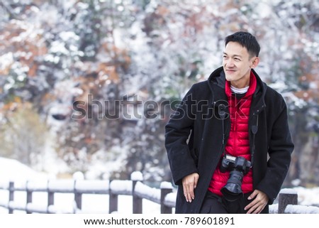 Outdoor portrait of handsome man in red and black coat. Fashion photo. Beauty winter style
