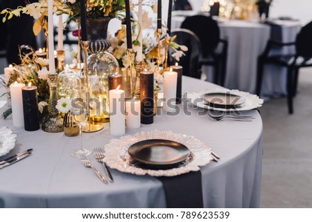Dinner table decorated by candles and flowers. Wedding. Decor Royalty-Free Stock Photo #789623539