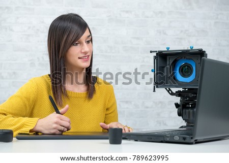 a young woman video editor working in studio