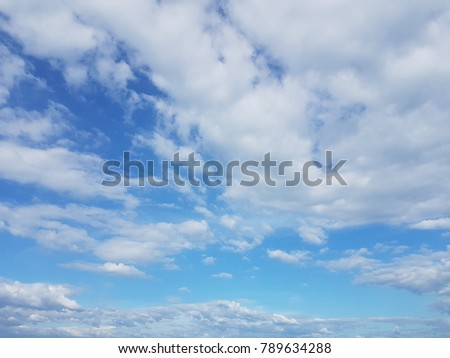 blue sky background with white fluffy clouds.