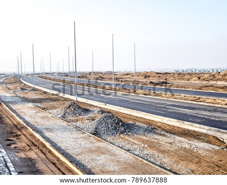 Under construction road in the city with lighting poles