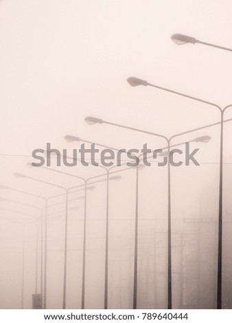 The Light Poles in a Row in The Fog Held